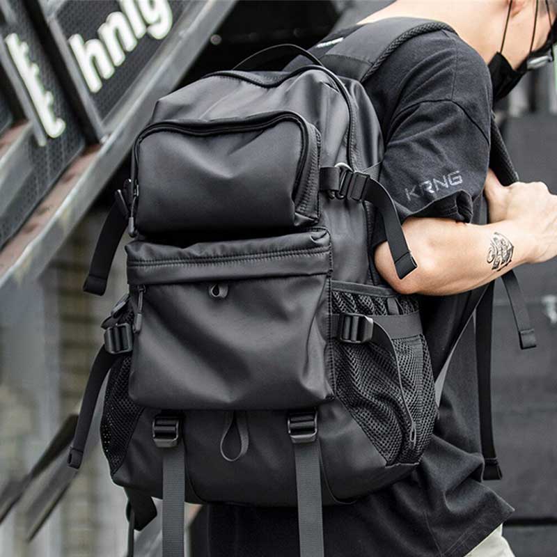 Man with Black Tactical Backpack and a techwear shirt