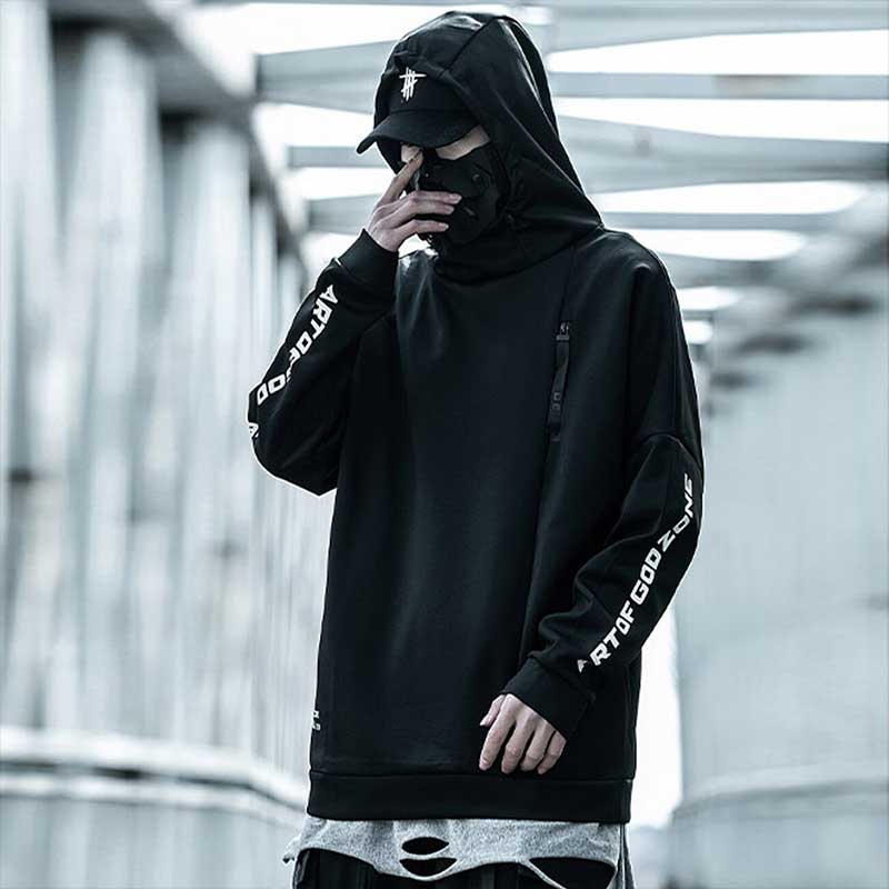 Man wearing a black techwear hoodie and a black face mask