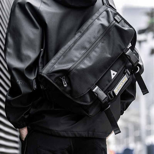 Man wearing a pupil travel bag on shoulders with a black techwear coat