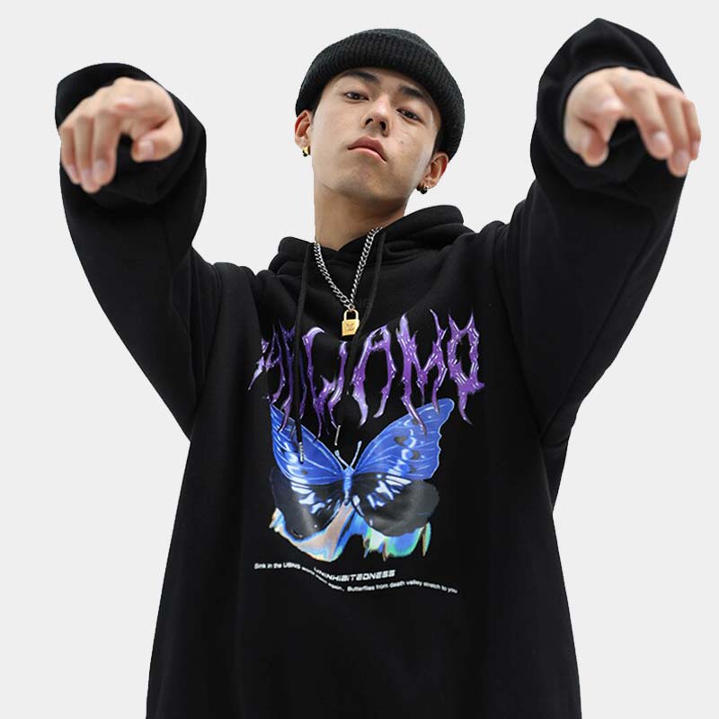 Man wearing a black butterfly hoodie with a chain necklace