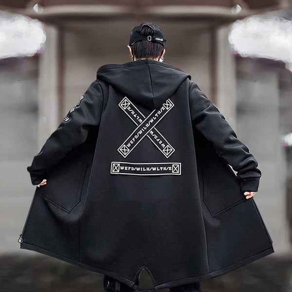 Man wearing a black techwear jacket with a cross design printed