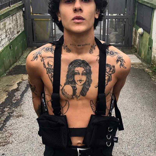 Man wearing a black fanny pack vest and tattoo