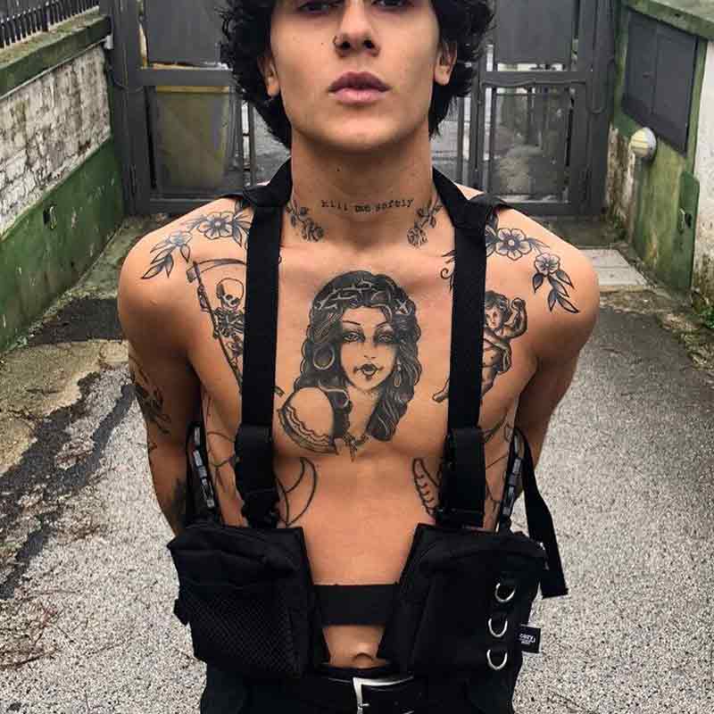 Man wearing a black fanny pack vest and tattoo