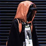 man with orange Large capacity tactical backpack, black cap and techwear face mask