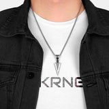 Man wearing mens arrowhead necklace with a black techwear shirt and a streetwear shirt