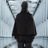 man wearing a techwear cyberpunk cloack with black techwear pant