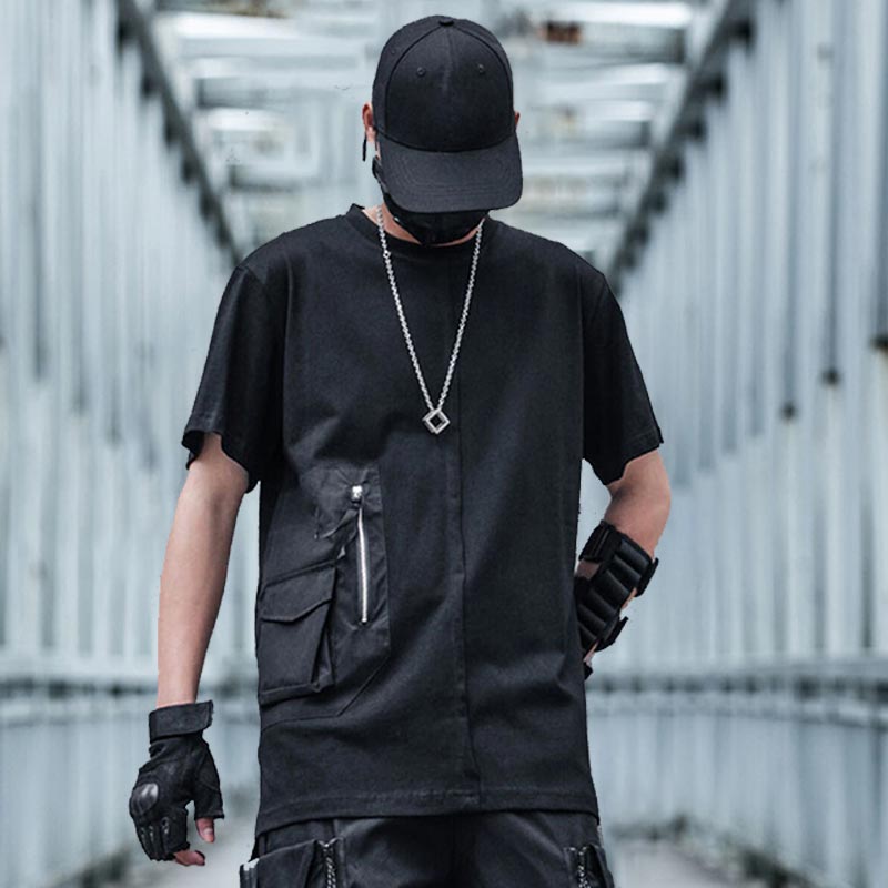 man wearing a techwear shirt with pockets and a black cap
