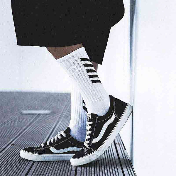 Man wearing urban outfitters socks with black sneakers and techwear short