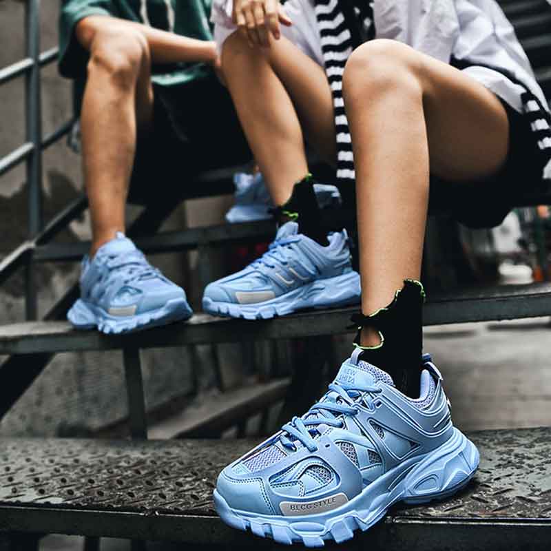 a man and a woman wearing blue urban sport sneakers wit short and t-shirt